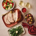 Sliced porchetta roast with rosemary potatoes, green beans and vegetables, festive holiday dinner meal kit.